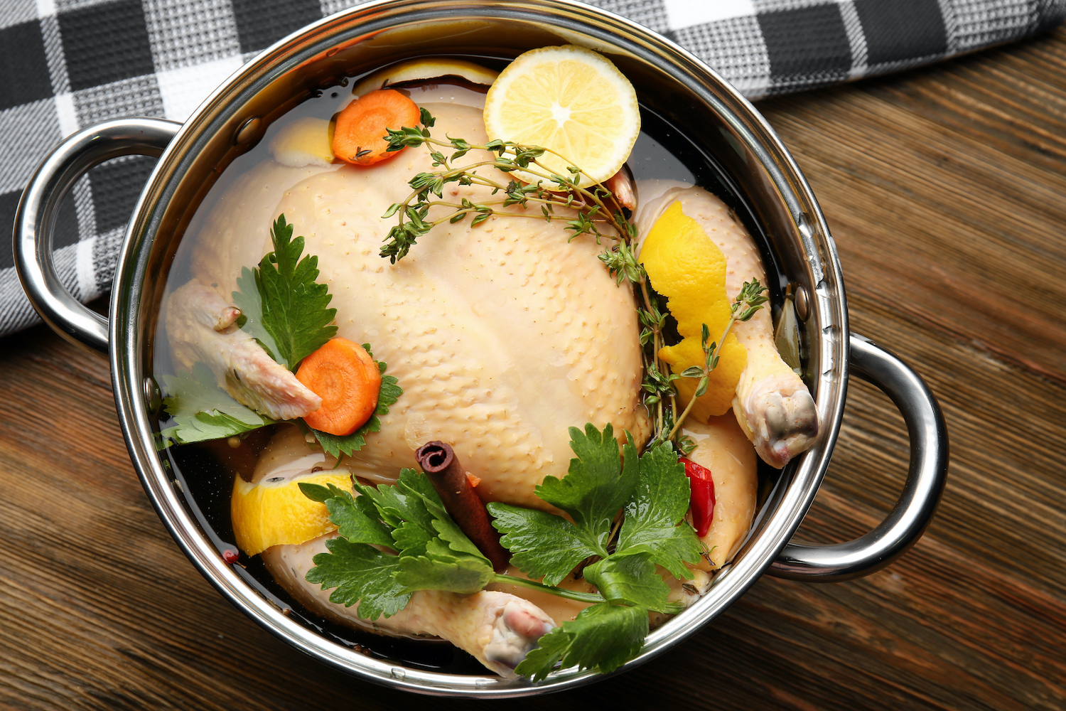 brined turkey with herbs in pot