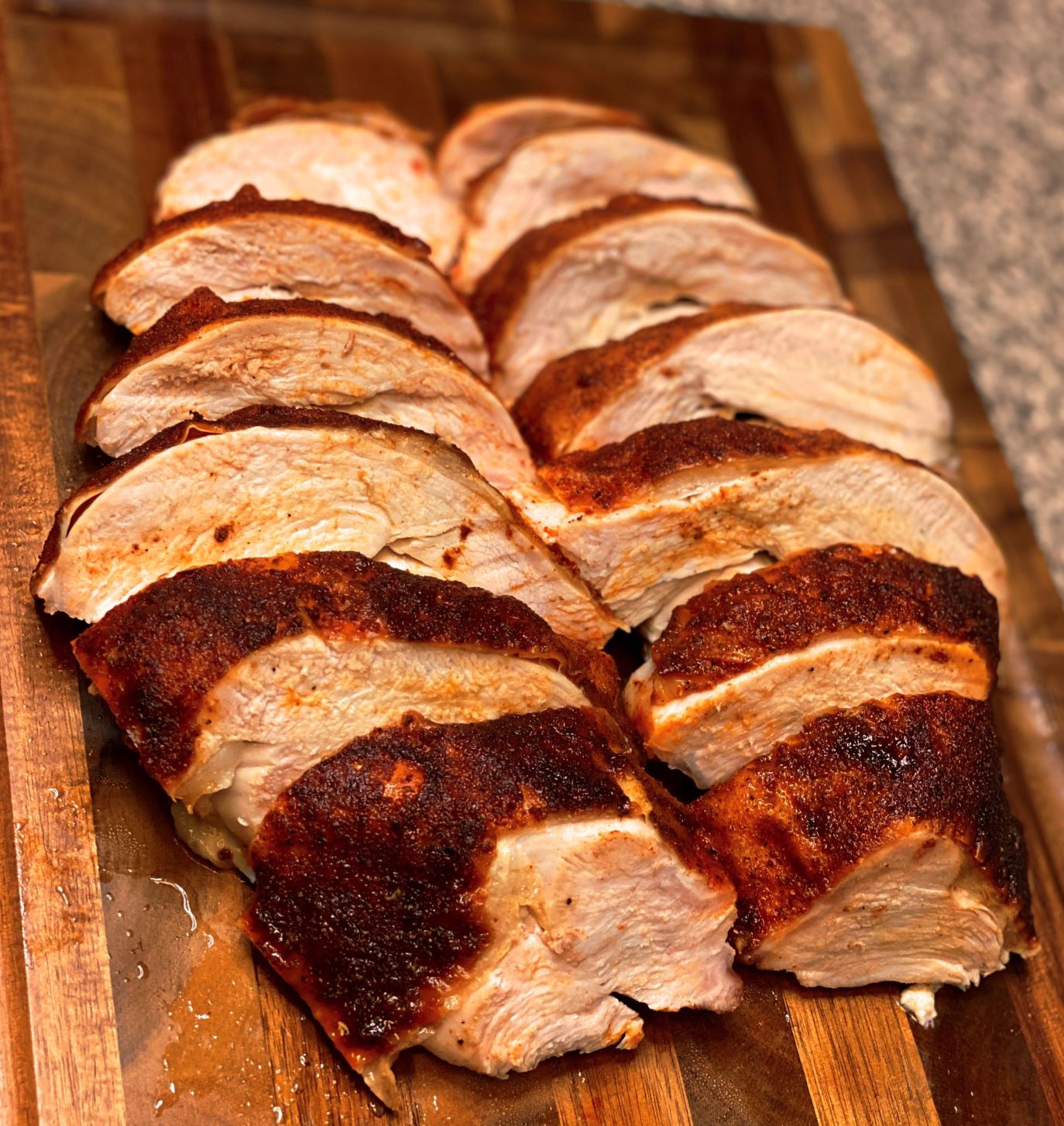 sliced turkey breast on wood board